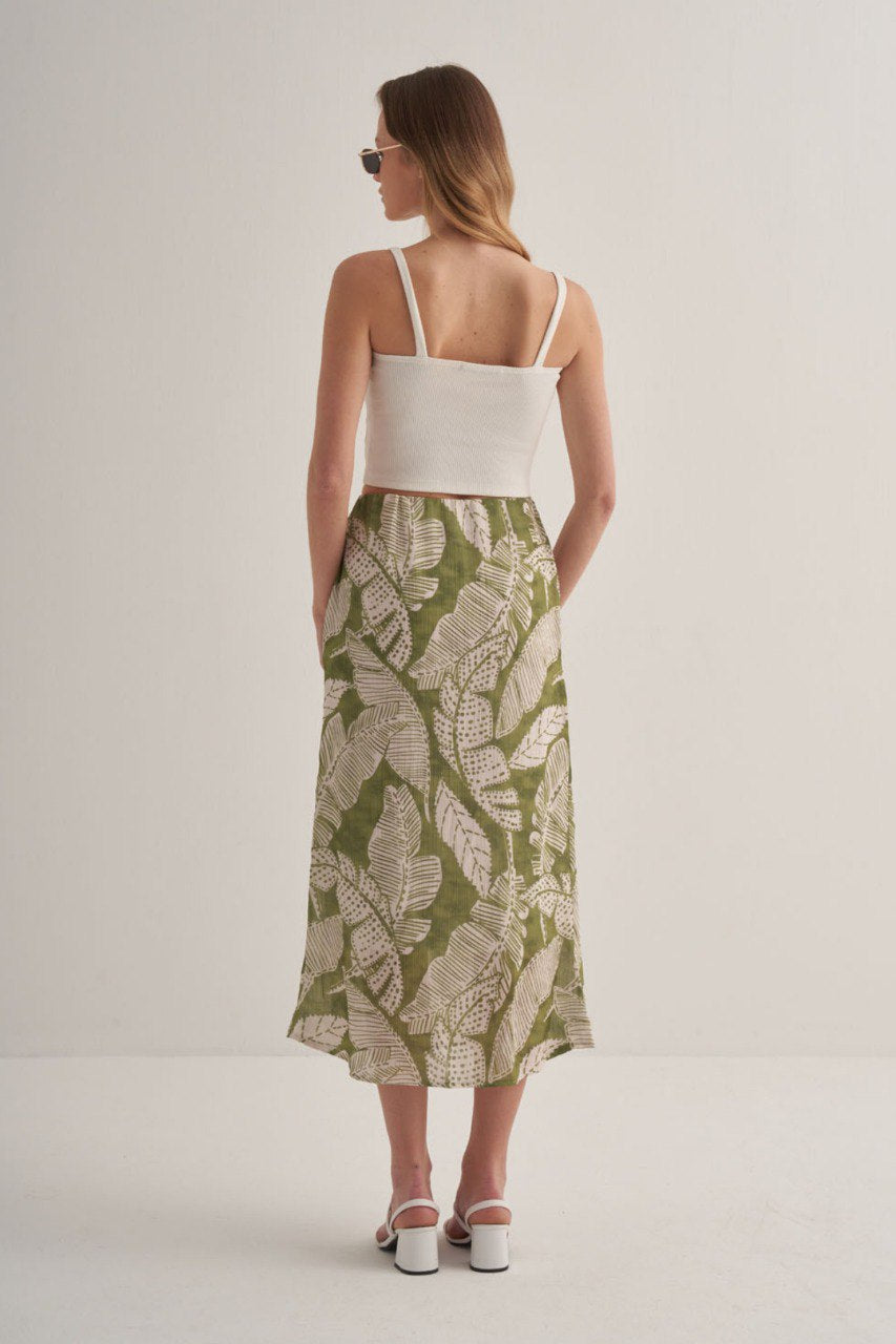Back view of the green botanical midi skirt featuring flowy lightweight fabric.