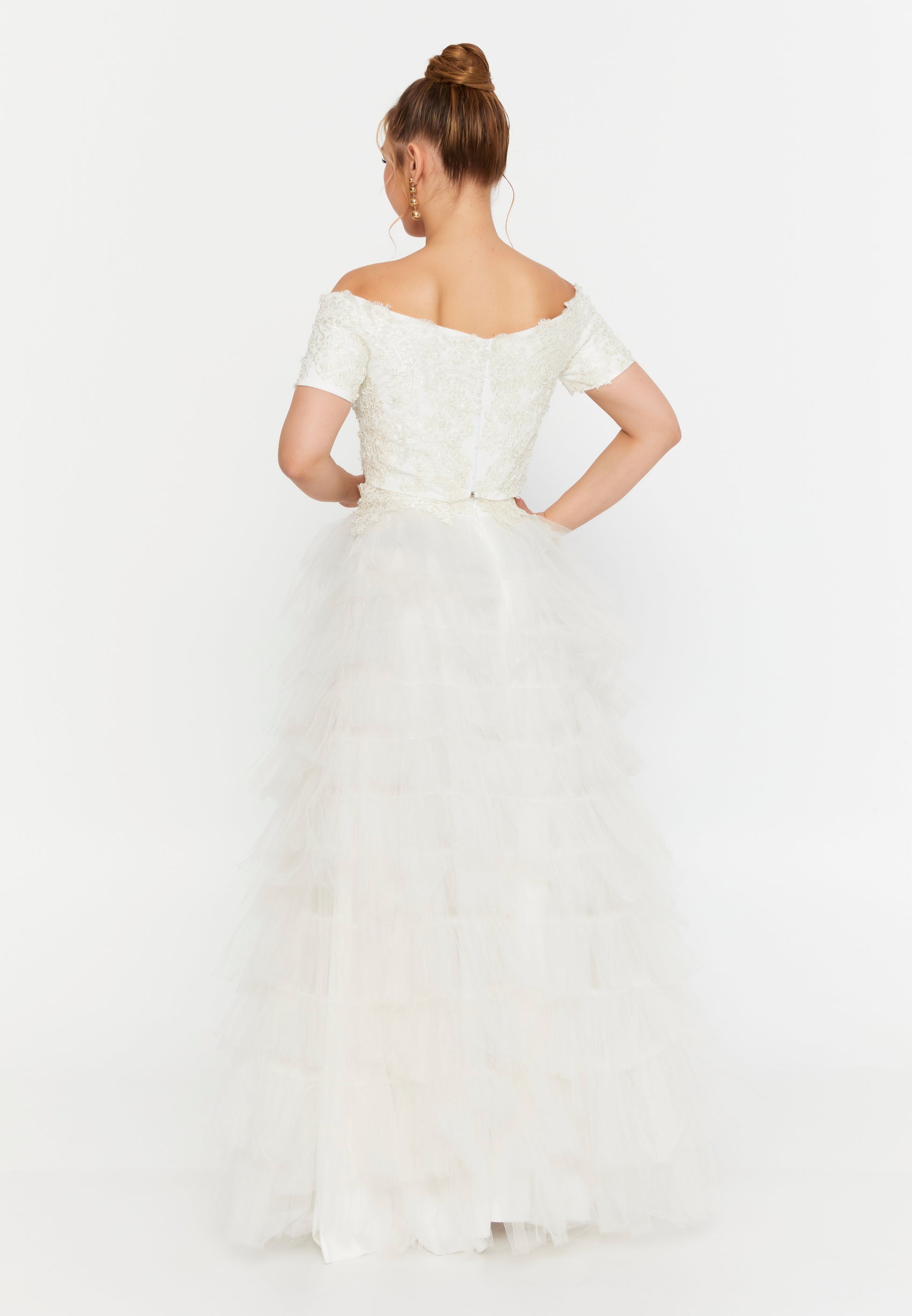 Model in white lace off-shoulder crop top and layered tulle skirt bridal 2-piece outfit