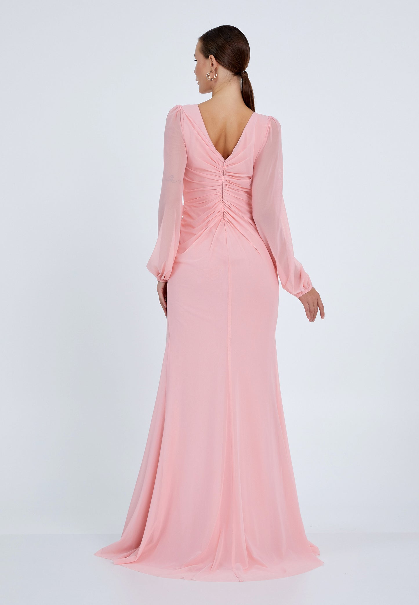 Back view of long-sleeve pink evening gown with V-shaped back