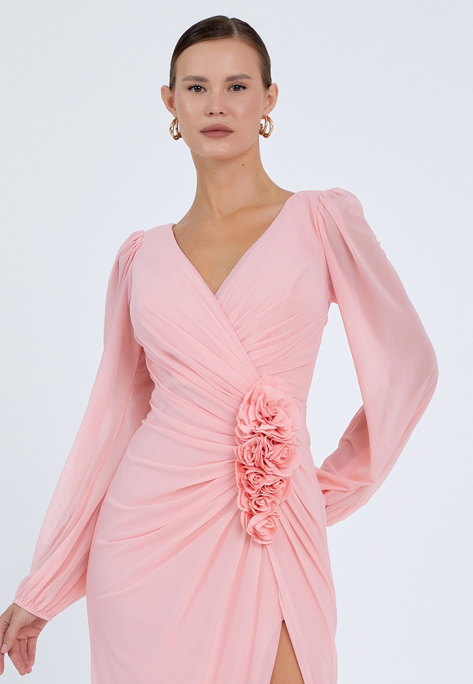 Close-up of pink dress floral detailing and draped waist