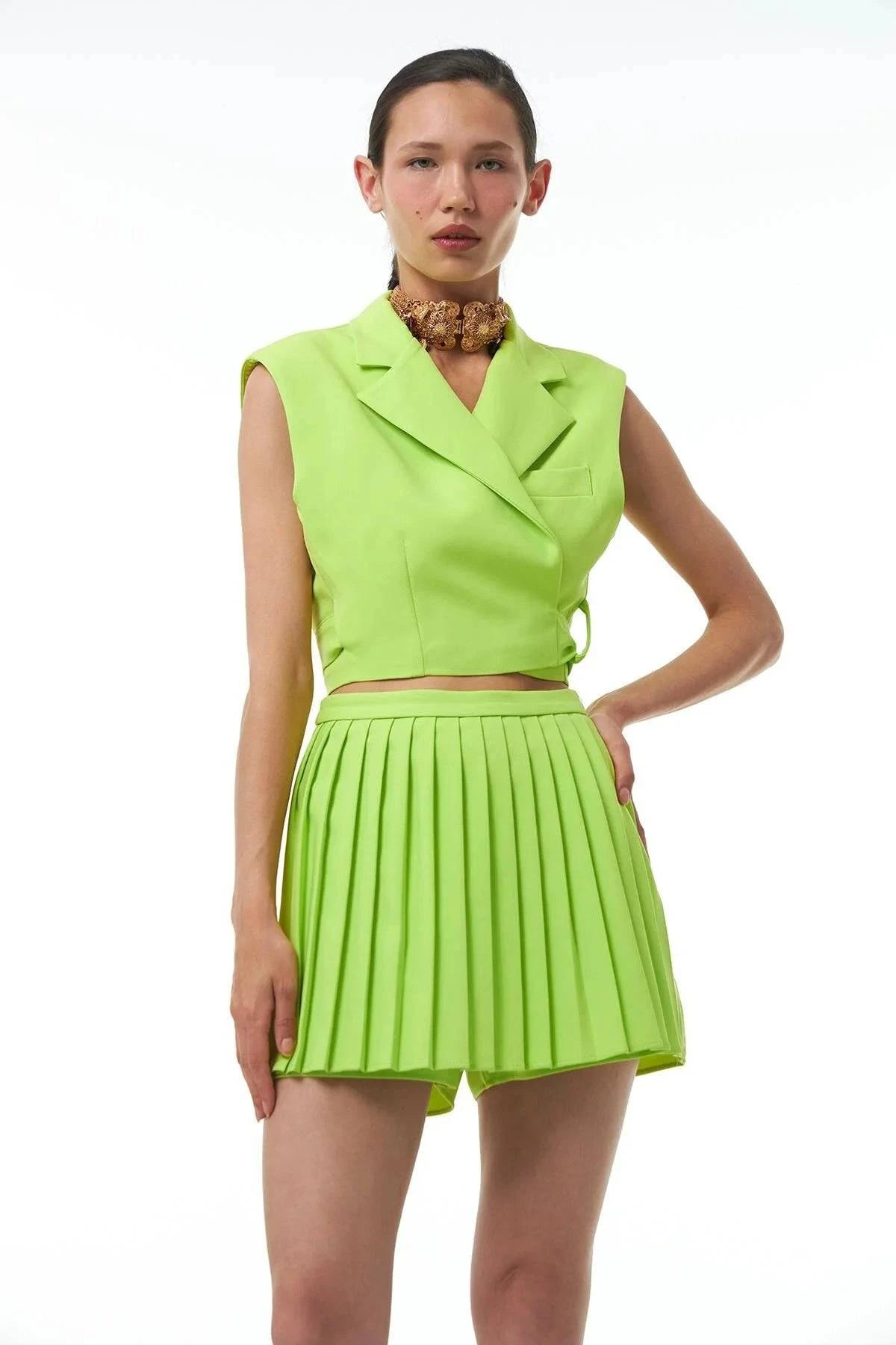 Trendy neon mini skort with pleating and vibrant color details.